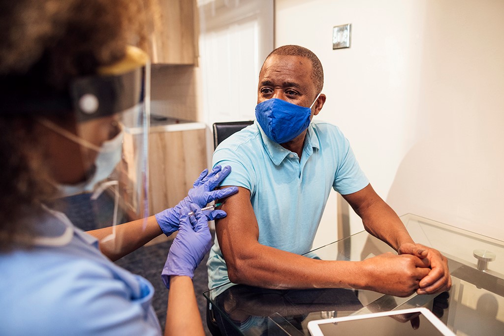 Vaccination of a gentleman wearing a facemask