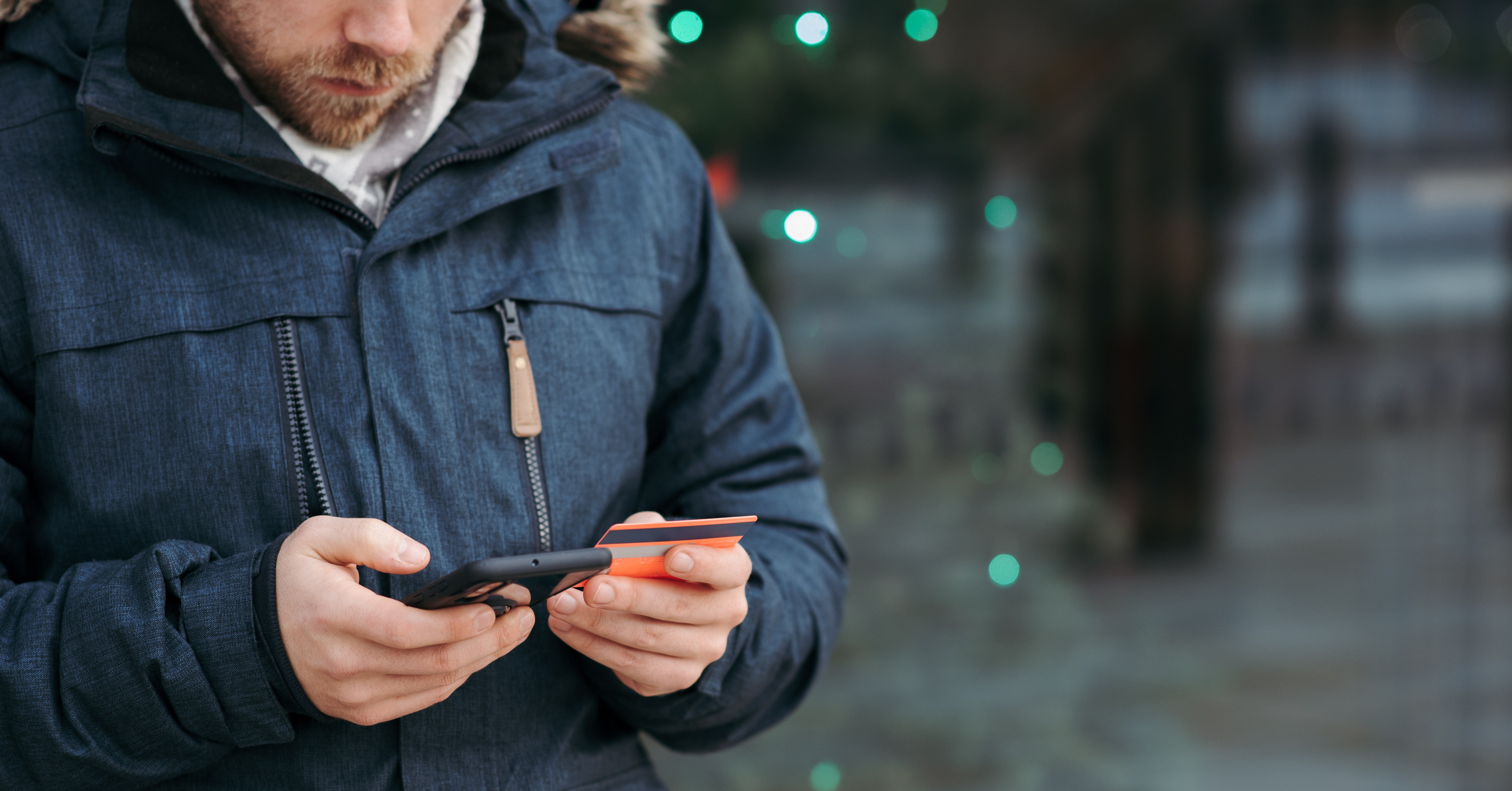 Man using his mobile phone to purchase an item.